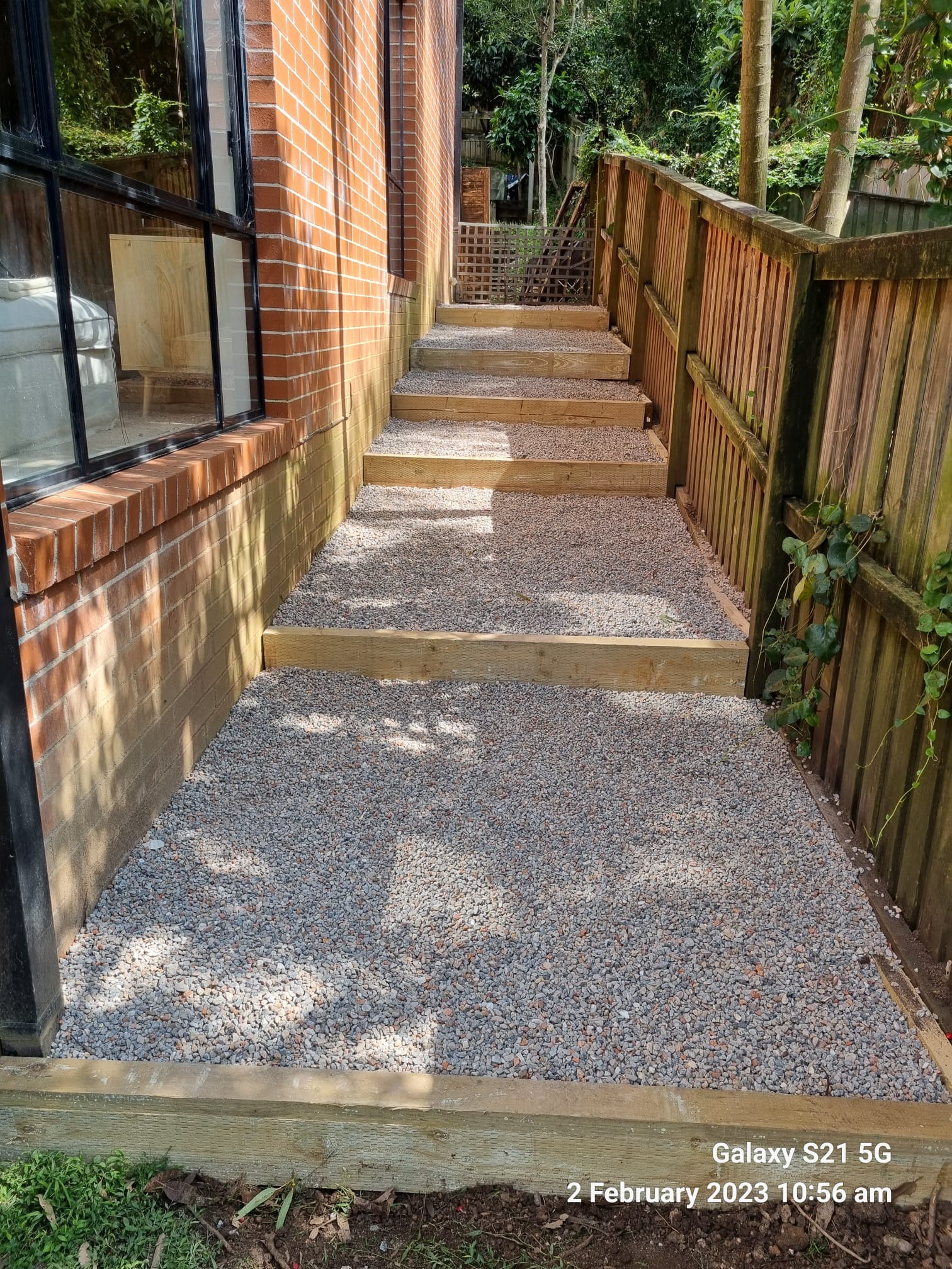 Landscaped driveway and retaining wall completed by Active Landscapes