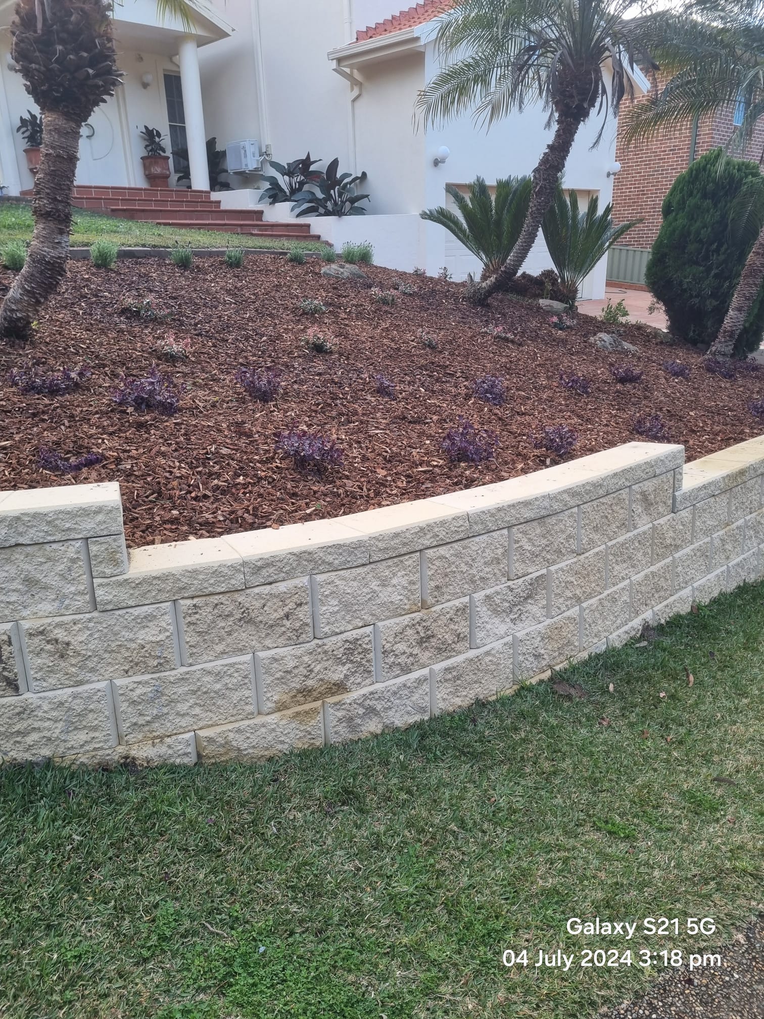 Landscaped driveway and retaining wall completed by Active Landscapes
