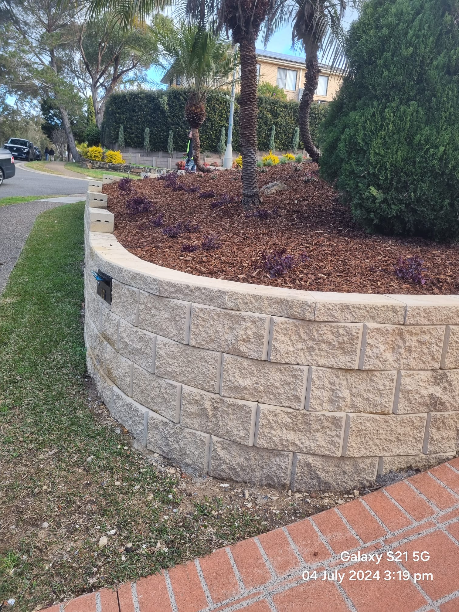 Landscaped driveway and retaining wall completed by Active Landscapes