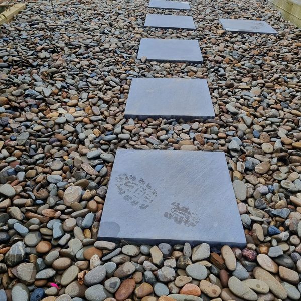 Bluestone stepping pavers set into a bed of river pebbles