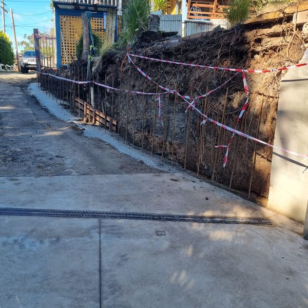 Excavated bank with steel reinforcement bars set ready for a concrete wall