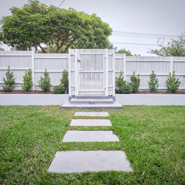 Level landscaped lawn with stone stepping pavers