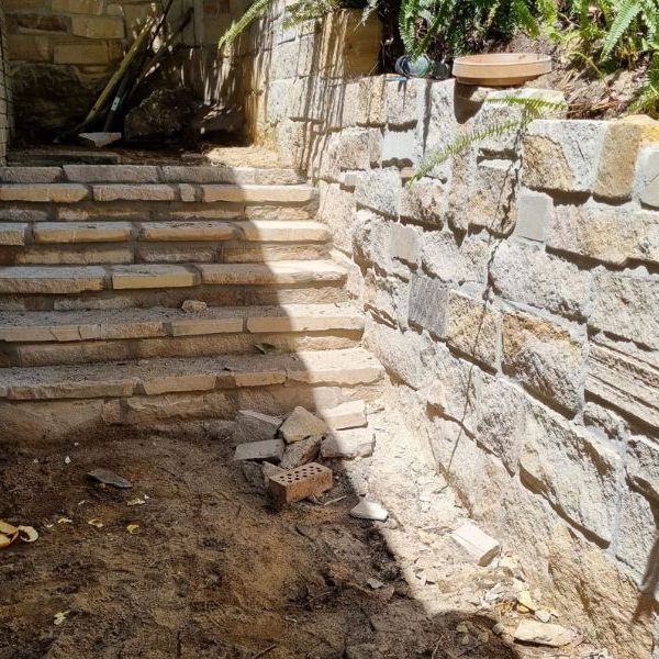Sandstone retaining wall beside cut stone steps