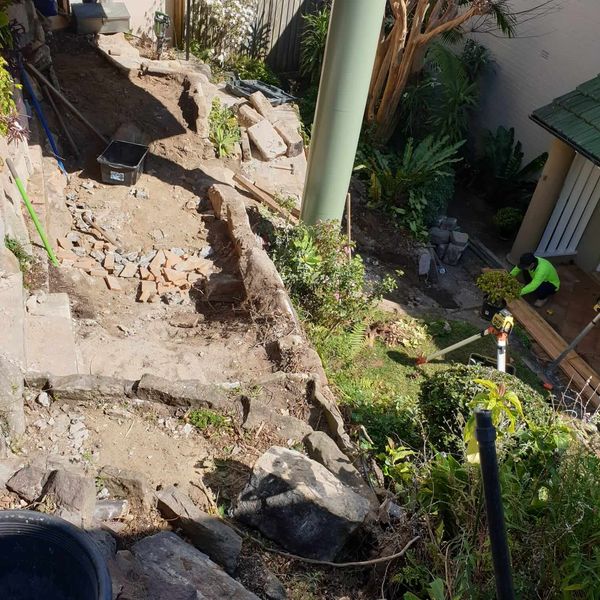 Excavation and rock removal under way in a sloping garden