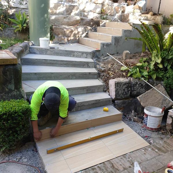 Paving being cut and laid across a run of garden steps